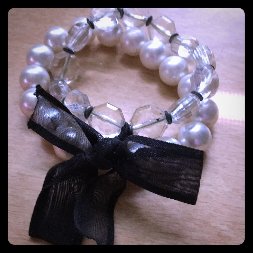 Two bracelets connected with bow